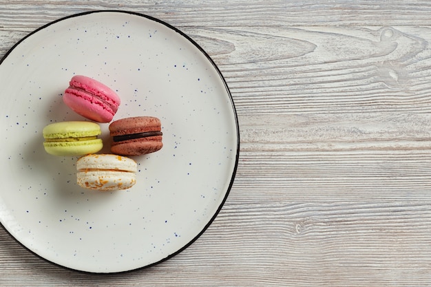 Macaroon cookies on plate, pile of macaroons