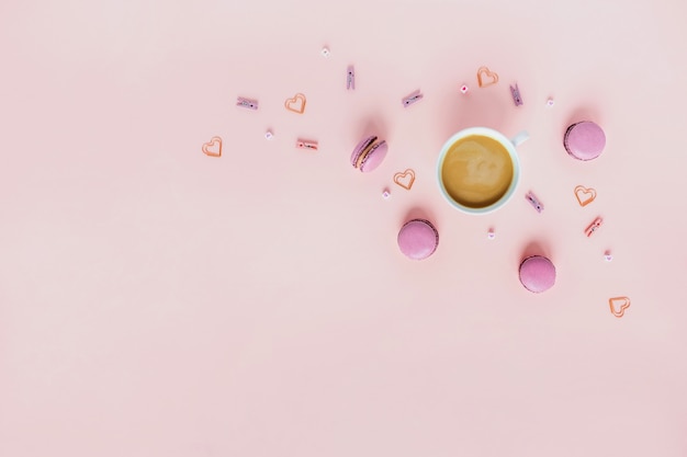 Macaroons and a Cup of coffee on pink