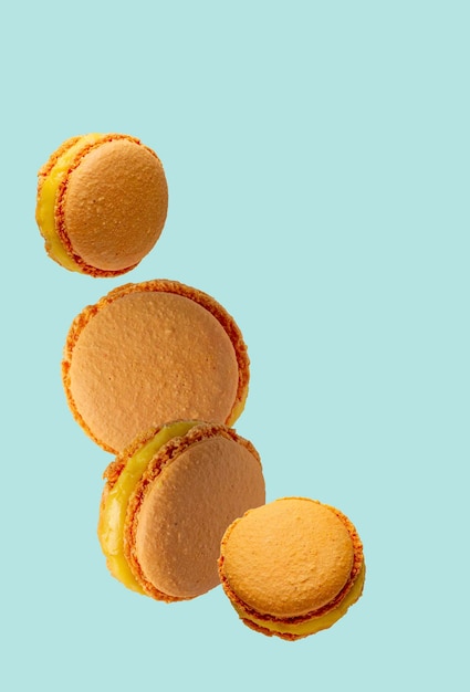 Французский десерт миндальное печенье с апельсиновой начинкой на синем фоне копией пространства