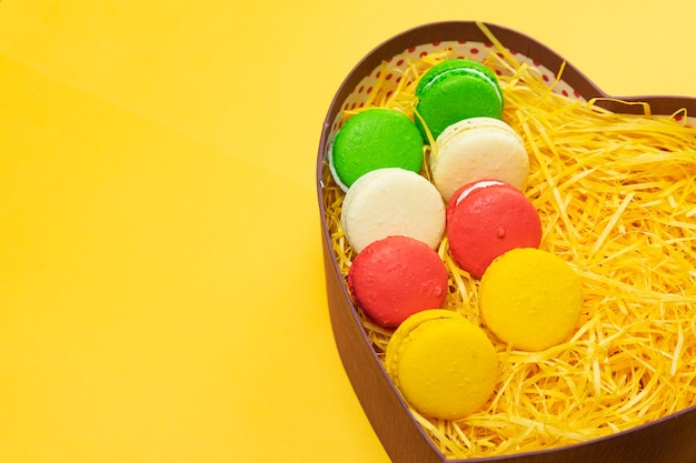 Macaroons in a gift box. Heart-shaped box. Copy space.