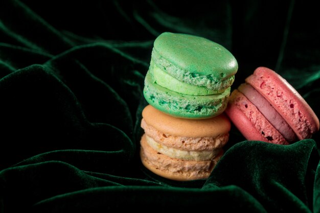 Macaroons on green velvet surface