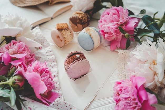 Macaroons and peonies flat lay top view