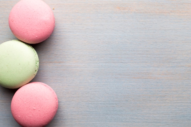 Macaroons and  the table. Dessert background. 