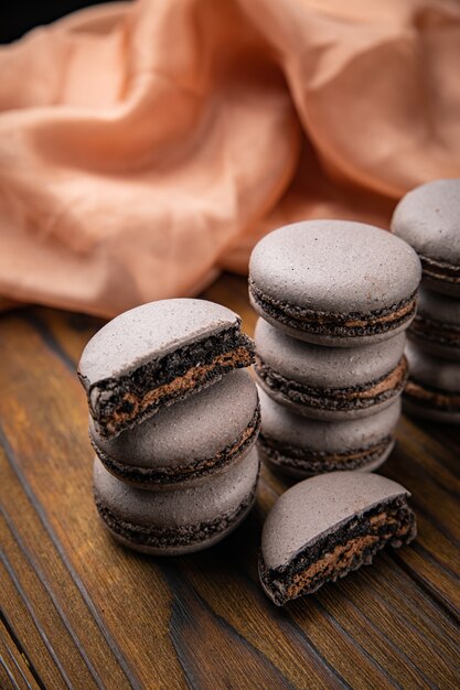 Macaroons with berries on a wooden table