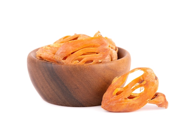 Mace in a wooden bowl, isolated on white background. Nutmeg flower, myristica fragrans. Natural spice, asian seasoning.