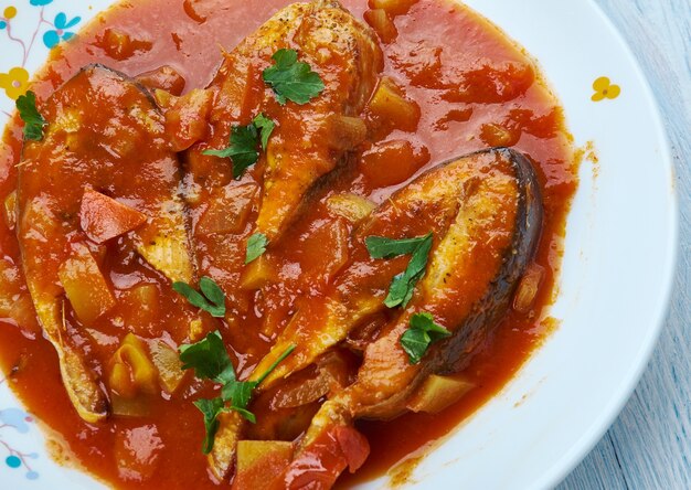 Machcha Besarou, fried fish marinated in turmeric and cooked in mustard, garlic and tomatoes is a typical Oriya dish