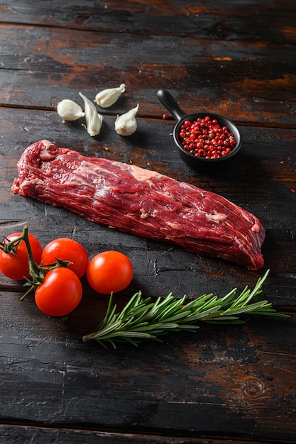 Machete steak raw cut  or hanging tende cut, with rosemary over wood background