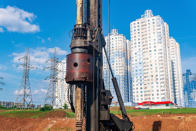 Machine for drilling deep piles against the backdrop of residential areas