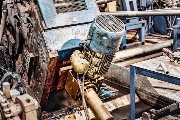 Machine for induction heating of metal A metal rod heated in an induction furnace Hot metal processing Metalworking in the industrial workshop at the factory