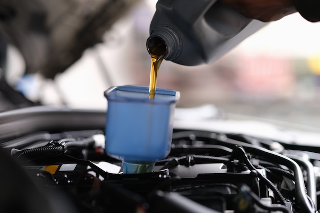 Machine oil for a car is poured into a container