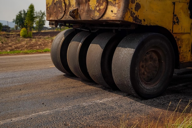 Machine and roller on asphalting to repair road of in the countryside