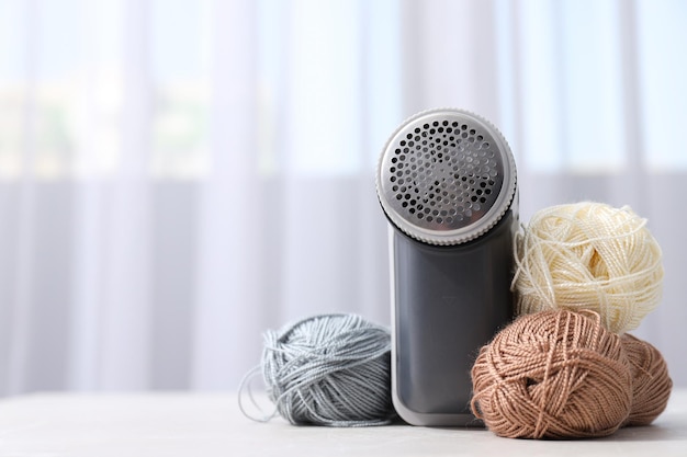 A machine for shaving fabric on clothes with tangles of threads nearby