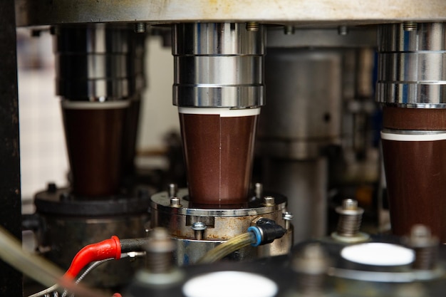 A machine with a metal pipe that has the word chocolate on it.