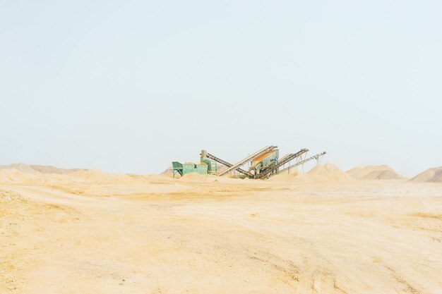 Photo machinery at quarry against clear sky