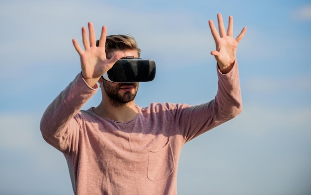 Macho man wear wireless VR glasses. Enjoying new experience. Digital future and innovation. guy virtual reality goggles. sexy man sky background vr glasses. male reality. looking so modern.