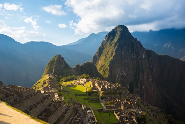 Machu Picchu on the mountain ridge view from above sunset light