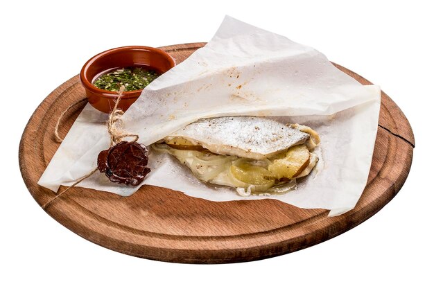 Mackerel baked in parchment on a wooden board