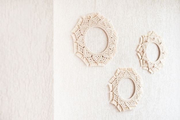 Macrame mandalas. Macrame wreathes on a white background. Natural cotton thread. Eco home decor. Soft focus. Copy space