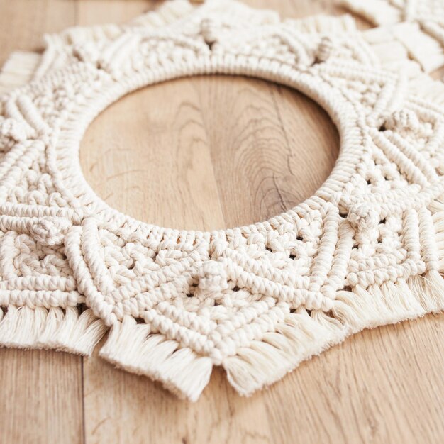 Macrame mandalas Macrame wreathes on a wooden background close up Natural cotton thread Eco home decor Soft focus