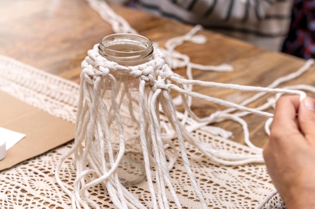 Macrame workshop Woman weaving macrame panels for home decor