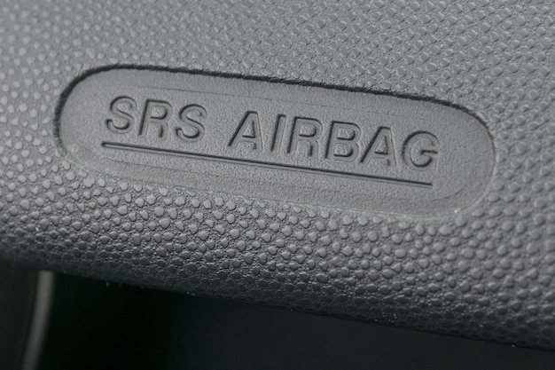 macro of an airbag sign on a dashboard