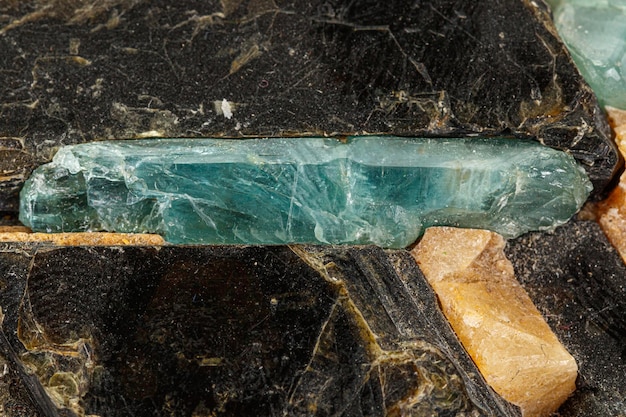 Macro aquamarine mineral stone in rock on white background