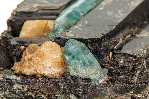 Macro aquamarine mineral stone in rock on white background