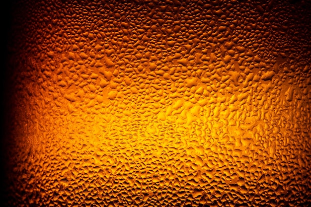 Macro beer bottle texture,water drops texture on the bottle of\
beer. abstract background,water drops