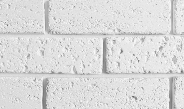 Macro brick wall texture. White textured wallpaper.