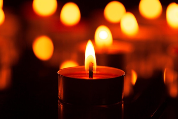 macro candle,candles that are lit in the dark,Many candles burn with a shallow depth of field.