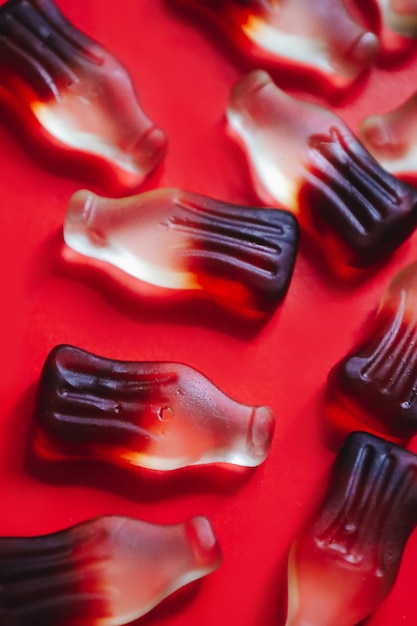 Macro cola gummy jelly candies pattern, bottle shaped sweets for chewing