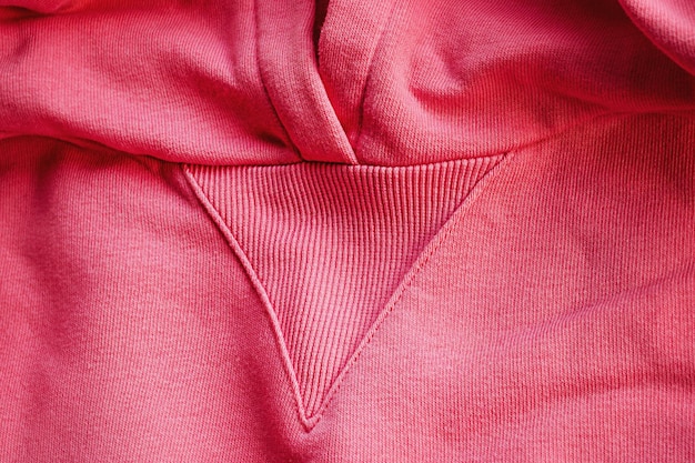 Macro detail of pink knitted hoodie fabric as a background