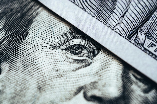 Macro face and eyes of a hundred dollar bill Money and finance concept