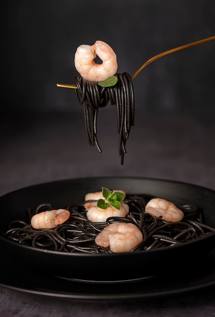 Macro food photography of black spaghetti and shrimps