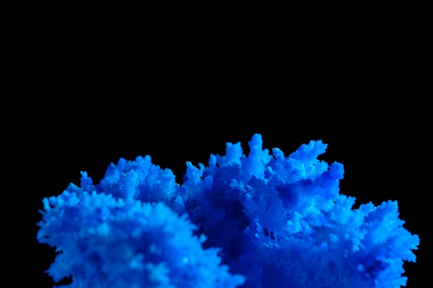 Macro image blue salt crystal on black background