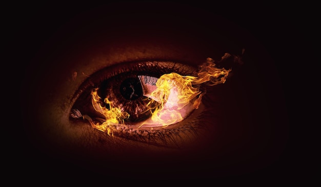 Macro image of human eye in fire. Mixed media