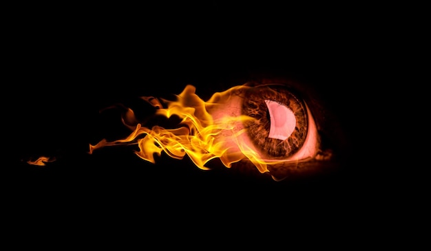 Macro image of human eye in fire. Mixed media