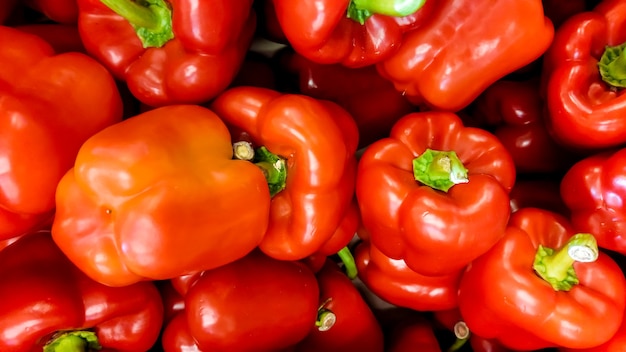 Macro image of lots of red paprica lying on store counter. Texture or pattern of fresh ripe vegetables