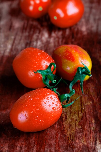 Macro images of tomatoes closeup on wooden table