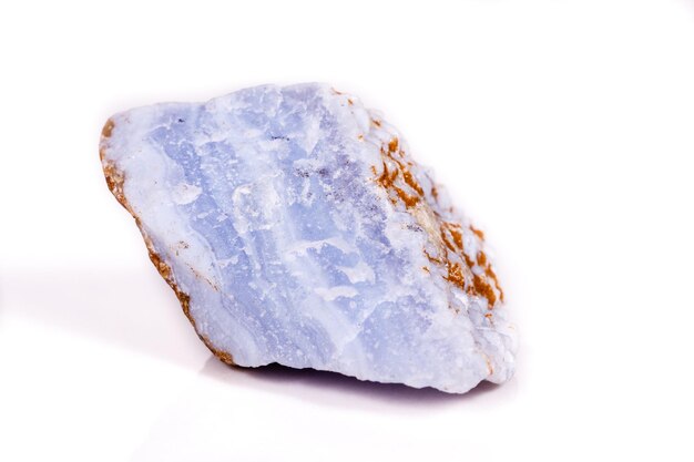 Macro mineral blue agate in the rock on white background