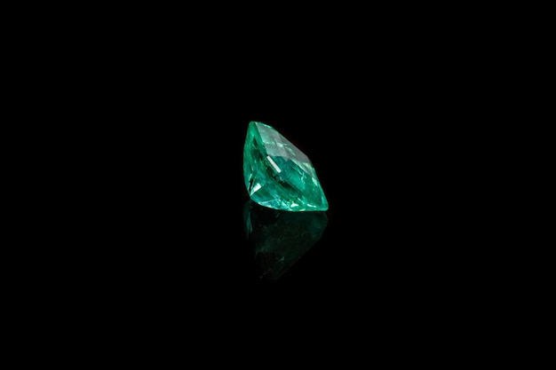 Macro mineral Emerald gemstone faceted on black background