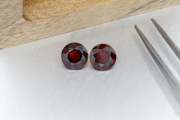 Macro mineral faceted stone cut Garnet on a gray background