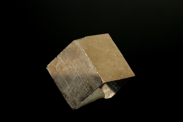 Macro mineral pyrite stone on a black background