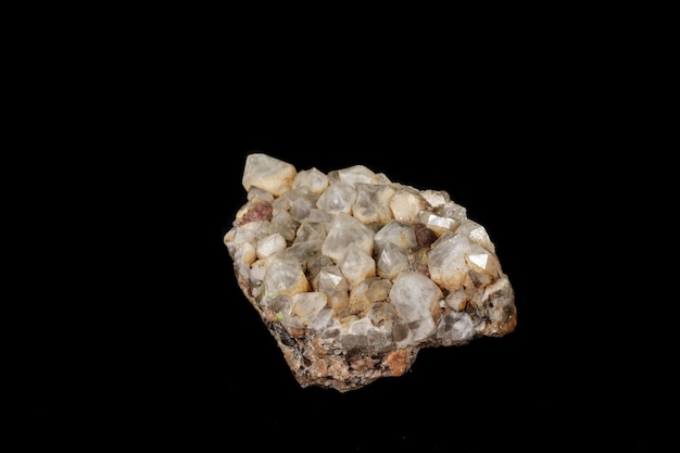 Macro mineral quartz stone with fluorite on granite on a black background