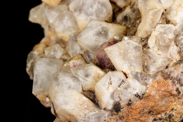 Macro mineral quartz stone with fluorite on granite on a black background