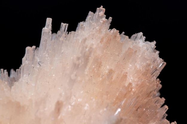 Macro mineral Scolecite stone on a black background