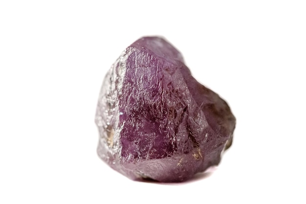 Macro mineral stone alexandrite red violet in daylight on a white