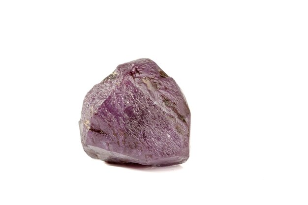 Macro mineral stone alexandrite red violet in daylight on a white