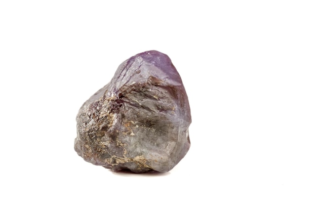 Macro mineral stone alexandrite red violet in daylight on a white