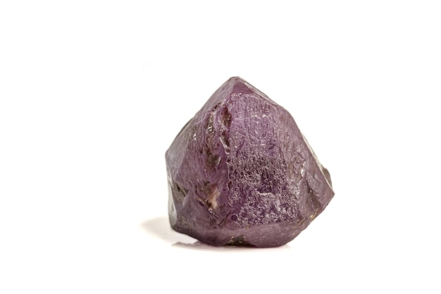 Macro mineral stone alexandrite red violet in daylight on a white